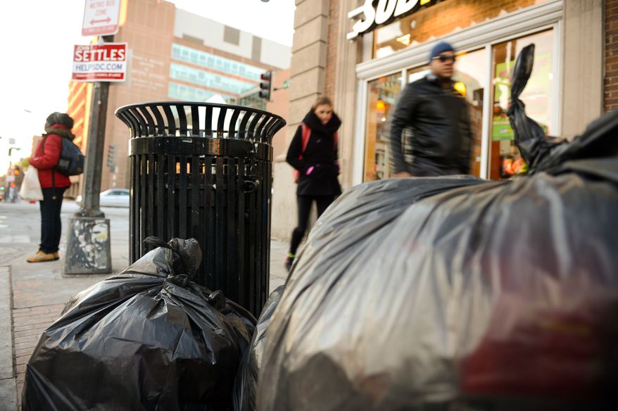 Trash lays on the ground ready to be picked up on the corner of U and 14th Streets in Northwest, Washington, D.C., Wednesday, January 29, 2014. (Andrew Harnik/The Washington Times)