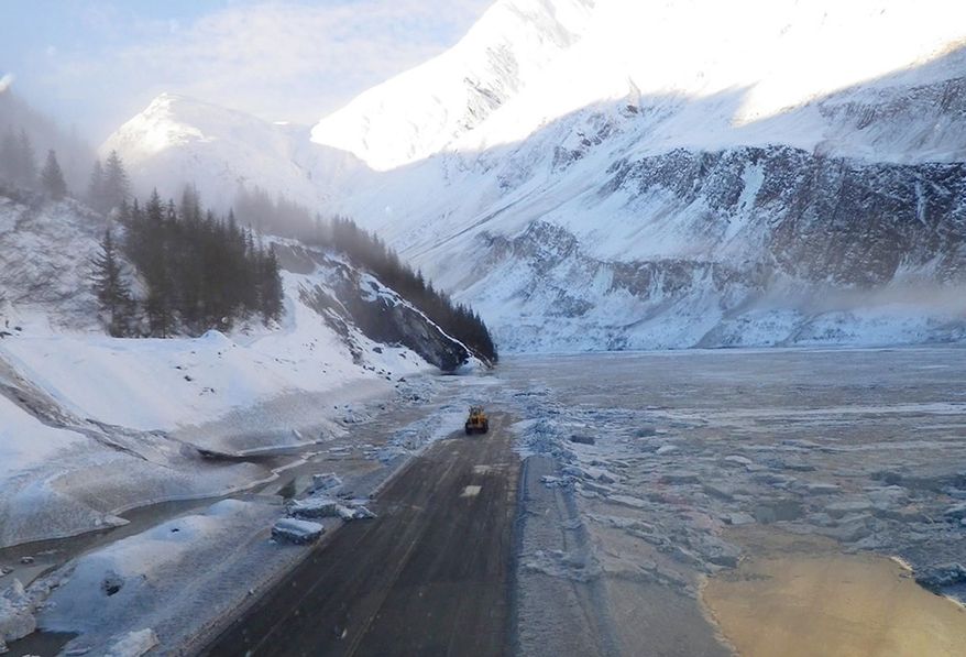 A photo released Wednesday Jan. 29, 2014, by the Alaska Department of Transportation & Public Facilities and made on Jan. 25, 2014, shows road crews beginning the job of clearing the closed Richardson Highway, near Valdez, Alaska. At least a dozen avalanches dumped snow on sections of the roadway Friday along 27 miles of the highway, the only road access to the city at the end of the trans-Alaska pipeline.(AP Photo/Alaska DOT&PF)