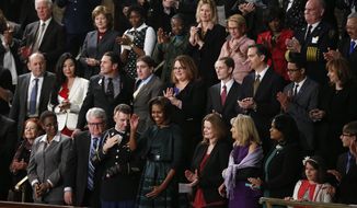 ** ADDS NAMES ** First lady Michelle Obama waves as she arrives for President Barack Obama&#39;s State of the Union address on Capitol Hill in Washington, Tuesday Jan. 28, 2014. Front row, second from left are, Sabrina Simone Jenkins, Craig, Remsburg, Sgt. 1st Class Cory Remsburg, first lady Michelle Obama, Misty DeMars, Jill Biden, Kathy Hollowell-Makle, Aliana Arzola-Pinero and Joey Hudy. Second row, third from left are, Jeff Bauman, Carlos Arredondo, Amanda Shelly, Nick Chute, John Soranno, Estiven Rodriguez, and General Motors CEO Mary Barra. Third row, second from right are, Antoinette Tuff, and Moore (Okla.) Fire Chief Gary Bird, right. (AP Photo/Charles Dharapak)