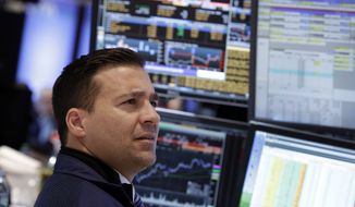 Specialist Paul Cosentino works at his post on the floor of the New York Stock Exchange Wednesday, Jan. 29, 2014. The U.S. stock market stumbled briefly after the Federal Reserve decided to further reduce its economic stimulus. (AP Photo/Richard Drew)