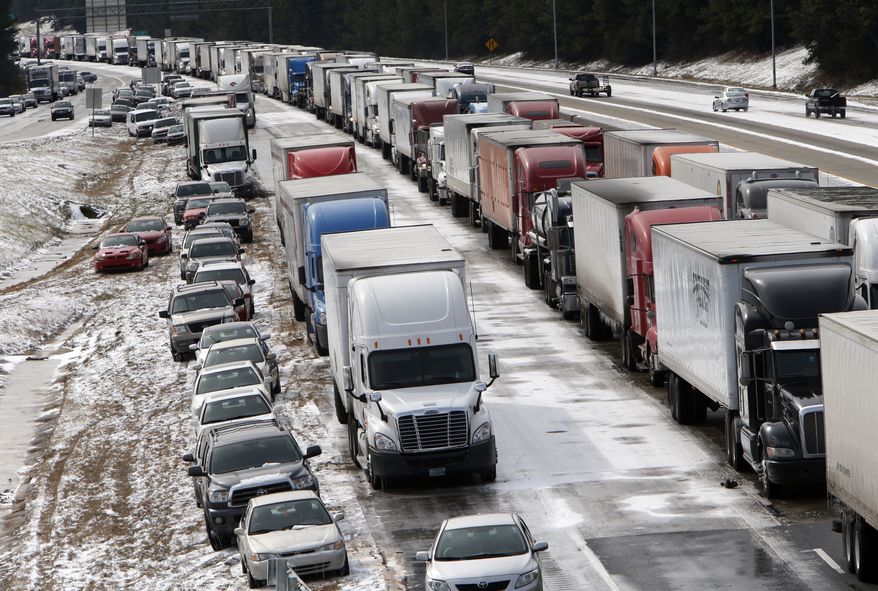 Traffic is at a standstill on Interstate 459 at US highway 280 as officials work to clear abandoned vehicles Wednesday January 29, 2014 in Birmingham, Ala. The winter storm that hit Alabama on Tuesday was wider and more severe than many officials expected. (AP Photo/Hal Yeager)