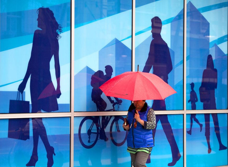 A woman uses an umbrella to shield herself from the rain as she passes by a mural in the window of an office building on the K Street Mall on Wednesday, January 29, 2013 in Sacramento, Calif. Sacramento had its first rain after 52 days without rain. The National Oceanic and Atmospheric Administration's Web site is predicting a tenth of an inch of rain in San Francisco over the next two days and more than 2 inches in parts of Sacramento. (AP Photo/The Sacramento Bee, Randy Pench) MAGS OUT; LOCAL TV OUT (KCRA3, KXTV10, KOVR13, KUVS19, KMAZ31, KTXL40); MANDATORY CREDIT