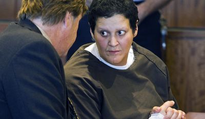 FILE - In this Oct. 24, 2013 file photo, Tanya Singleton, right, cousin of former New England Patriots football player Aaron Hernandez, speaks with defense attorney Peter Parker during a bail hearing at Superior Court in Fall River, Mass. Singleton was released on bail Thursday, Jan. 30, 2013, more than five months after her indictment on two charges in connection with the murder case against Hernandez. (AP Photo/Boston Herald, Dominick Reuter, Pool, File)