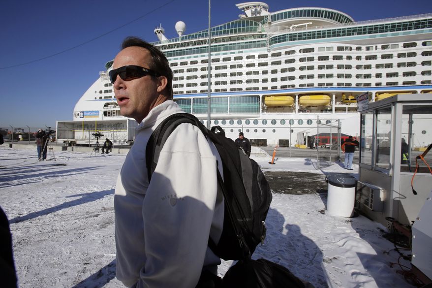 Rick O'Shea answers a question as he waits to board the Explorer of the Seas cruise ship after it docked at a berth in Bayonne, N.J., Wednesday, Jan. 29, 2014. O'Shea says his company BYOPlanet services is preparing to disinfect the ship. The number of passengers and crew reported stricken ill on the cruise ship has risen to nearly 700. (AP Photo/Mel Evans)