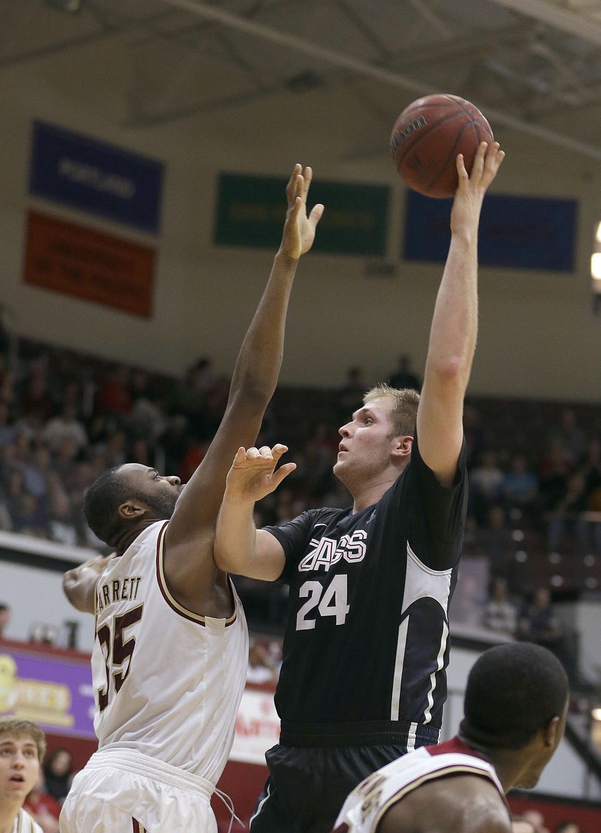 Gonzaga center Przemek Karnowski (24) takes a shot over Santa Clara center Robert Garrett (35) during the first half of an NCAA college basketball game Wednesday, Jan. 29, 2014, in Santa Clara, Calif. (AP Photo/Tony Avelar)