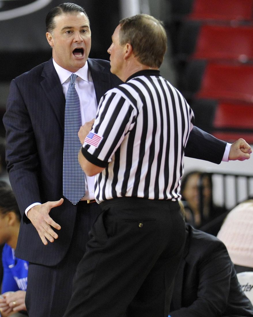 Kentucky head coach Matthew Mitchell, left, argues with a referee after a Kentucky player was called for a foul during the first half of an NCAA college basketball game against Georgia,Thursday, Jan. 30, 2014, in Athens, Ga. (AP Photo/AJ Reynolds)