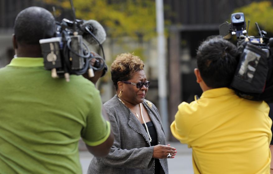 FILE- In an Oct. 4, 2012 file photo Emma Bell is followed by media outside the federal courthouse in Detroit. The woman who raised campaign money for former Detroit Mayor Kwame Kilpatrick is hoping to avoid prison for tax crimes. Bell was a key witness at Kilpatrick's corruption trial, telling jurors how she pulled cash from her bra to pay more than $200,000 in kickbacks when he was mayor. Bell is returning to court Thursday, Jan. 30, 2014 for her sentence for tax evasion. (AP Photo/The Detroit News, David Coates, FILE ) DETROIT FREE PRESS OUT; HUFFINGTON POST OUT