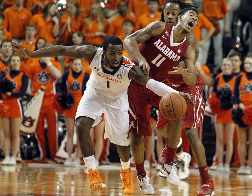 Auburn's KT Harrell (1) fouls Alabama's Shannon Hale (11) as he reaches for the ball during the first half of an NCAA college basketball game, Thursday, Jan. 30, 2014, in Auburn, Ala. (AP Photo/Butch Dill)