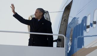 President Barack Obama waves as he boards Air Force One, Thursday, Jan. 30, 2014, at Andrews Air Force Base, Md., en route to Waukesha, Wis., to speak about job training. This trip to Waukesha, Wis., is part of a four-stop tour President Barack Obama is making to expand on themes from his State of the Union address. (AP Photo)