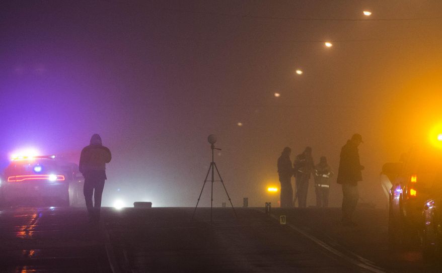 Law enforcement agents investigate a crime scene in Santaquin, Utah related to an officer-involved shooting, Thursday Jan. 30, 2014.(AP Photo/The Salt Lake Tribune, Keith Johnson)