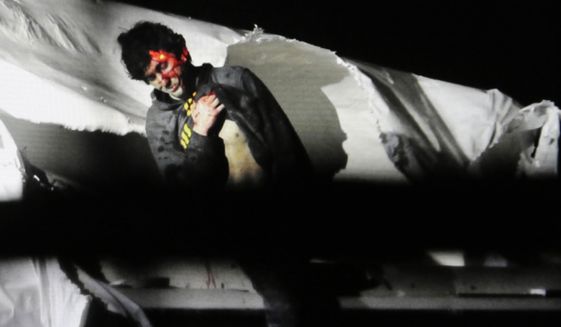 In this Friday, April 19, 2013, Massachusetts State Police file photo, 19-year-old Boston Marathon bombing suspect Dzhokhar Tsarnaev, bloody and disheveled with the red dot of a sniper&#39;s rifle laser sight on his head, emerges from a boat at the time of his capture by law enforcement authorities in Watertown, Mass. On Thursday, Jan. 30, 2014, U.S. Attorney General Eric Holder authorized the government to seek the death penalty in the case against Tsarnaev. (AP Photo/Massachusetts State Police, Sean Murphy, File)