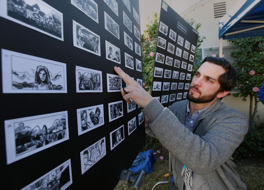 In this photo taken Jan. 13, 2014, Nathan Crow, Creative Director at RPA: Rubin Postaer and Associates, an advertisement agency, checks a story board in Pasadena, Calif., before a film crew films a commercial for Goldie Blox, a small business who was awarded the Intuit Small Business Big Game to be highlighted during the 2014 Super Bowl. Intuit, with the help of the public, selected Goldie Blox: Engineering Toys for Girls. (AP Photo/Nick Ut)