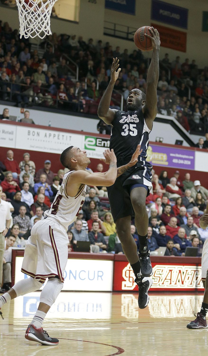 Gonzaga forward Sam Dower (35) drives the ball against Santa Clara guard Evan Roquemore in the first half of an NCAA college basketball game Wednesday, Jan. 29, 2014, in Santa Clara, Calif. (AP Photo/Tony Avelar)