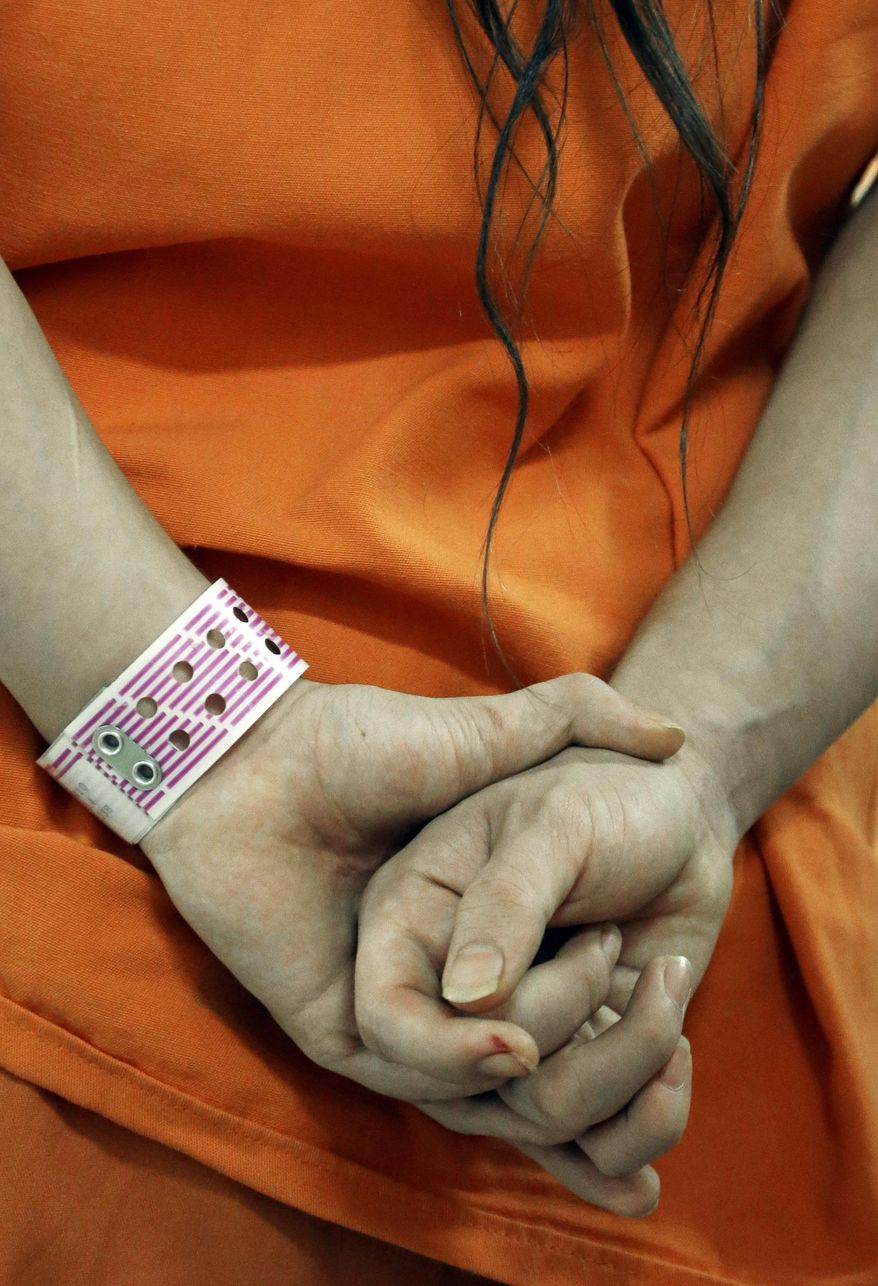 In this Dec. 10, 2013 an inmate wears his special purple wrist band in a new unit in the Harris County Jail for gay, bisexual and transgender inmates in Houston. Harris County, the third-largest in the country which processes some 125,000 inmates annually, is one of many around the country implementing changes to the way it treats its gay, lesbian, bisexual and transgender population. (AP Photo/Pat Sullivan)