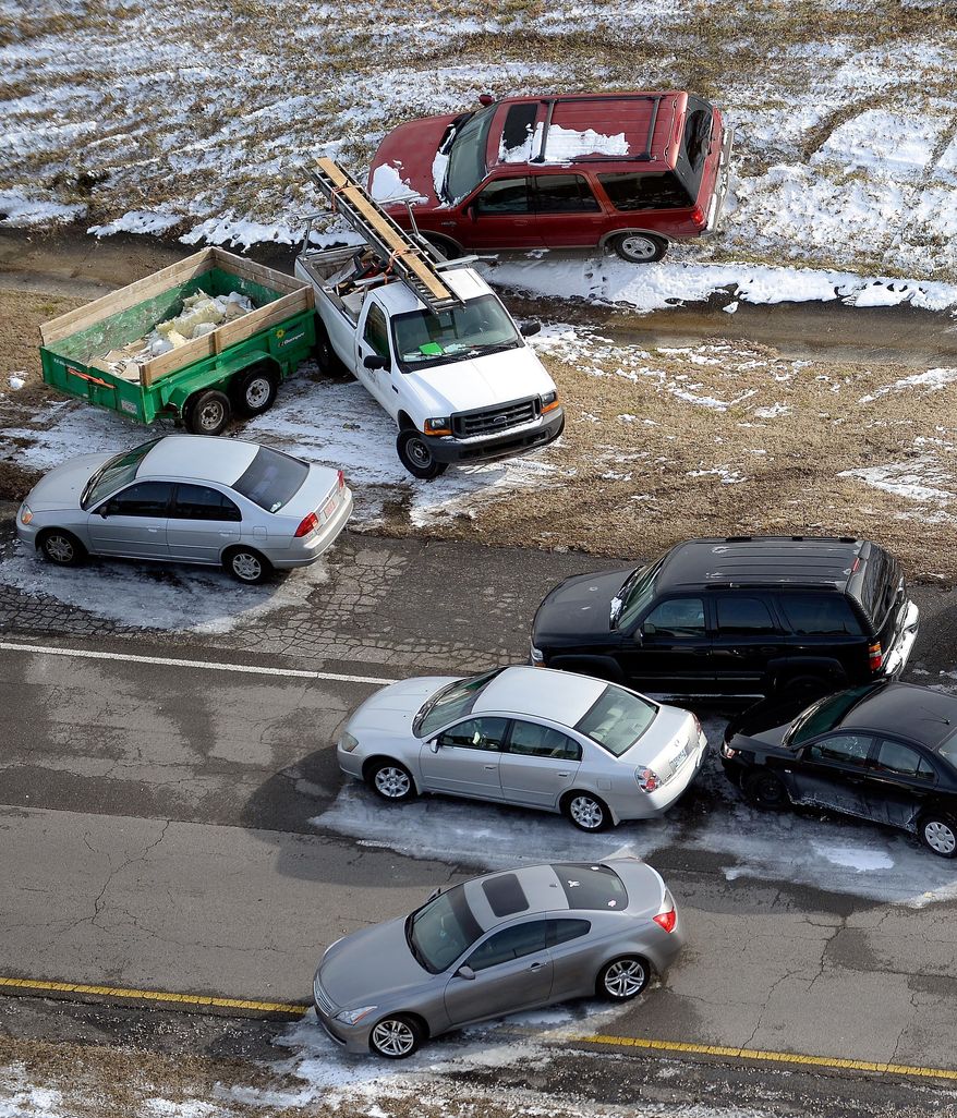 Abandoned cars and trucks litter the road after a winter snow storm slammed into the South and turned highways into parking lots, on Wednesday, Jan. 29, 2014, near Birmingham, Ala. after a winter storm hit the state on Tuesday. Thousands of wrecked and abandoned cars were scattered across Birmingham area roads Wednesday. The state Department of Transportation towed cars from Interstate 20 to make it passable. (AP Photo/David Tulis)