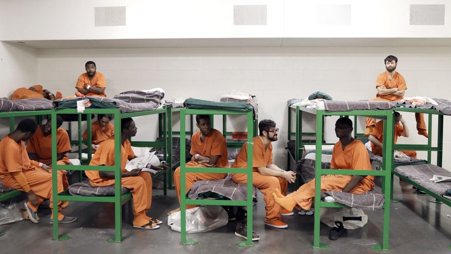 In this Dec. 10, 2013, photo inmates hang out on their bunks in a new unit in the Harris County Jail for gay, bisexual and transgender inmates in Houston. (AP Photo/Pat Sullivan)