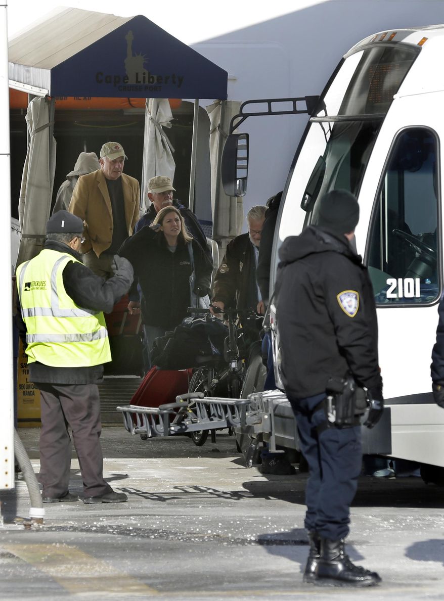 Passengers disembark from the Explorer of the Seas cruise ship to waiting buses after it docked in Bayonne, N.J., Wednesday, Jan. 29, 2014. The number of passengers and crew reported stricken ill on the cruise ship has risen to nearly 700. The U.S. Centers for Disease Control and Prevention said Wednesday its latest count puts the number of those sickened aboard the Explorer of the Seas at 630 passengers and 54 crew members. (AP Photo/Mel Evans)