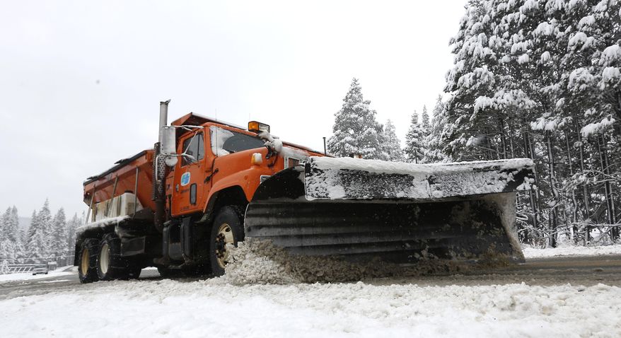 A snow plow clears snow from Highway 50 near Echo Summit, Thursday, Jan. 30, 2014. A overnight storm brought several inches of snow to the Sierra Nevada and rain to Northern California. (AP Photo)