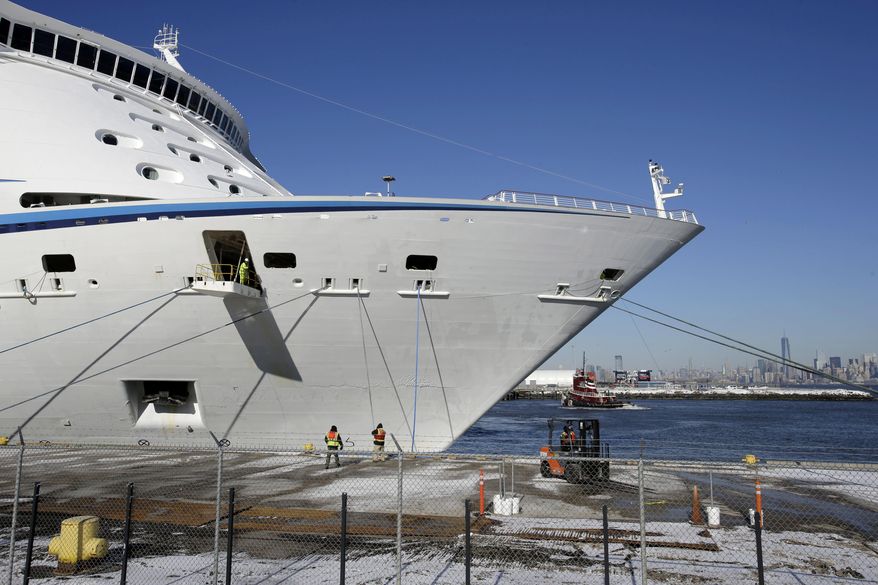 Workers dock the Explorer of the Seas cruise ship at a berth after arriving, Wednesday, Jan. 29, 2014, in Bayonne, N.J. The number of passengers and crew reported stricken ill on the cruise ship has risen to nearly 700. The U.S. Centers for Disease Control and Prevention said Wednesday its latest count puts the number of those sickened aboard the Explorer of the Seas at 630 passengers and 54 crew members. (AP Photo/Mel Evans)