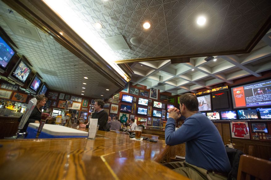 Patrons to the Crystal City Sports Pub watch various sporting programs on over 50 televisions, in Arlington, VA., Wednesday, January 30, 2014. (Andrew S Geraci/The Washington Times)
