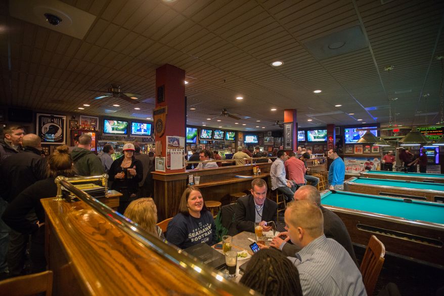 Patrons to the Crystal City Sports Pub watch various sporting programs on over 50 televisions, in Arlington, VA., Wednesday, January 30, 2014. (Andrew S Geraci/The Washington Times)