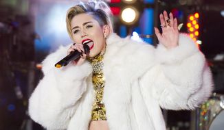In this Dec. 31, 2013 file photo, Miley Cyrus performs in Times Square during New Year&#39;s Eve celebrations in New York. Cyrus is kicking off her North American “Bangerz” tour Feb. 14, 2014, in Vancouver. “Ren and Stimpy” creator John Kricfalusi and LA contemporary artist Ben Jones have crafted videos to play during the 38 shows as Cyrus prioritizes singing over dance routines. (Photo by Charles Sykes/Invision/AP, File)