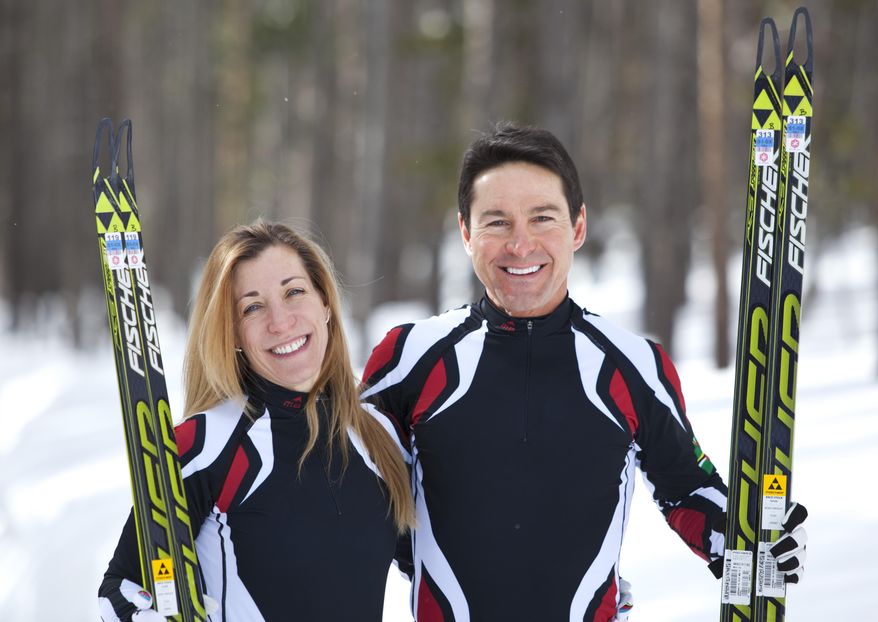 In this photo taken on Monday, Jan. 27, 2014, cross-country skiers Gary and Angelica di Silvestri pose for a photo at the Yellowstone Club in Big Sky, Mont. The American-born man and his Italian-born wife will be representing the tiny Caribbean island nation of Dominica at the Winter Olympics in Sochi next month. The former finance professionals, granted Dominica citizenship for their philanthropic work on the island, are finishing their training in Montana while hastily arranging their own visas, travel logistics and footing the bill for the entire expedition. (AP Photo/Janie Osborne)