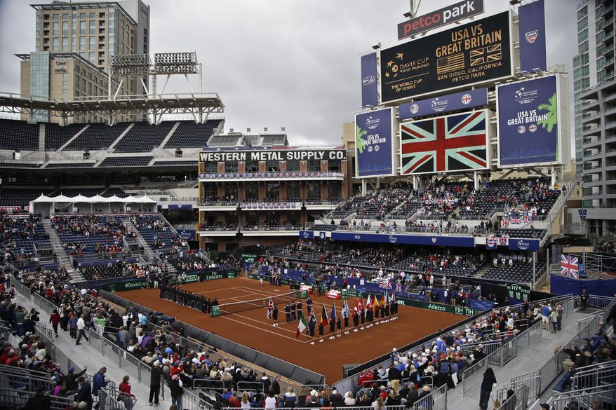 Players line the court during the pening ceremony for a Davis Cup tennis match between the United States and Great Britain, that takes place in the left field corner at Petco Park, home fo the San Diego Padres baseball team, Friday, Jan. 31, 2014, in San Diego. (AP Photo/Lenny Ignelzi)