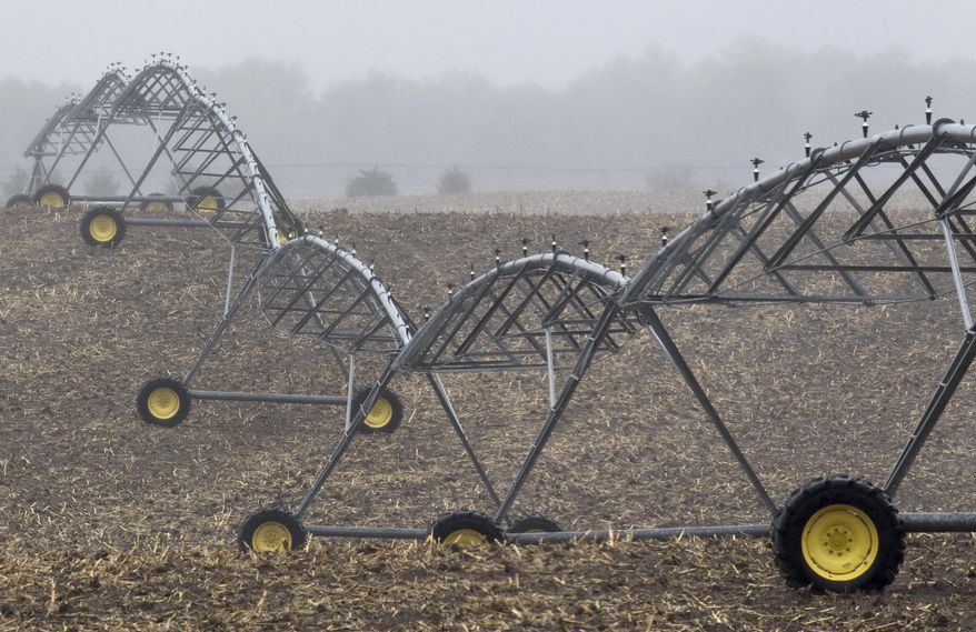 FILE - In this April 19, 2012, file photo, an irrigation pivot remains still along highway 14, several miles near the proposed new route for the Keystone XL pipeline in Neligh, Neb. In a move that disappointed environmental groups and cheered the oil industry, the Obama administration on Jan. 31, 2014, said it had no major environmental objections to the proposed Keystone XL oil pipeline from Canada. (AP Photo/Nati Harnik)