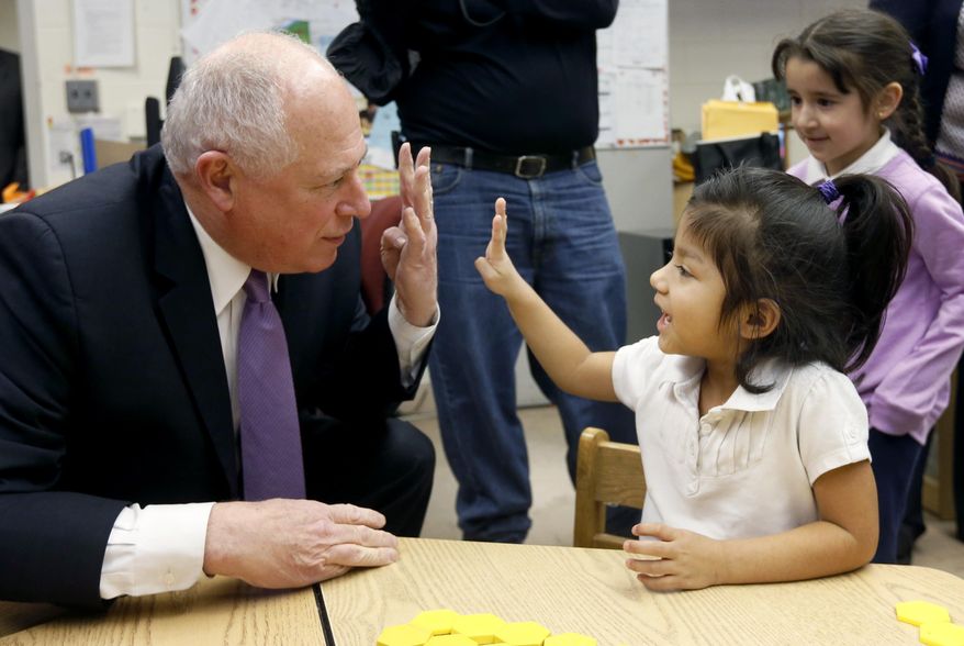 In this Thursday, Jan. 30, 2014 photo, Illinois Gov. Pat Quinn asks Anna Munoz her age as she replies enthusiastically, four, at the Edwards Center for Young Learners in Chicago. Quinn made his “ “Birth to Five” early education push a major cornerstone of this year’s annual address to lawmakers. Yet, he’s proposing boosting an area that’s often one of the first victims of budget cuts when times are looking lean, with over $800 million in cuts to education since 2009. (AP Photo/Charles Rex Arbogast)