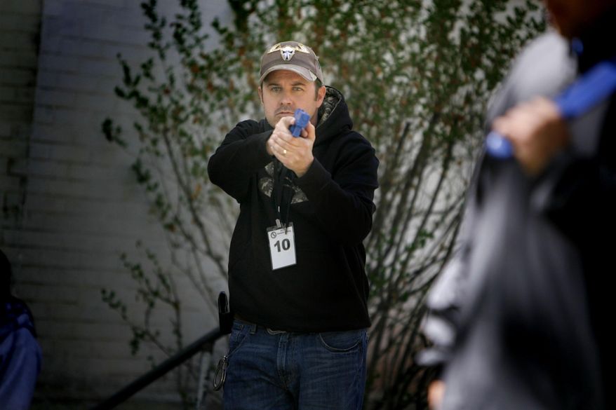 This 2004 file photo shows Utah County Sheriff's Sgt. Cory Wride, in a training exercise in Provo, Utah. A man with a rifle shot and killed Wride along a highway Thursday, Jan. 30, 2014, and wounded another deputy during a chase that stretched over 50 miles before he was caught, Utah County Sheriff Jim Tracy said. Wride had pulled up to a car that appeared disabled near Eagle Mountain when he was ambushed around 1 p.m. Thursday, the sheriff said. Eagle Mountain is a town about 35 miles south of Salt Lake City. (AP Photo/The Deseret News, Laura Seitz) SALT LAKE TRIBUNE OUT; MAGS OUT