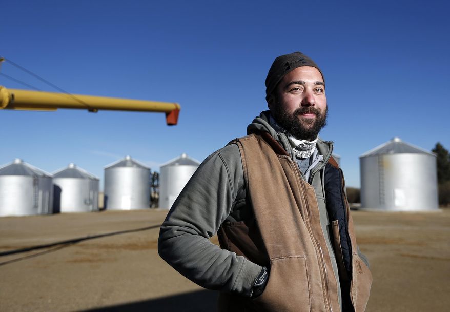 In this Jan. 28, 2014 photo, Matt Myers, 29, is the farm manager of the family farm 13 miles west of Big Sandy, Mont., where they grow spring and winter wheat. Myers grew up on the four-generation, 103-year-old farm and first drove a truck during harvest as a third-grader. (AP Photo/The Great Falls Tribune, Larry Beckner)