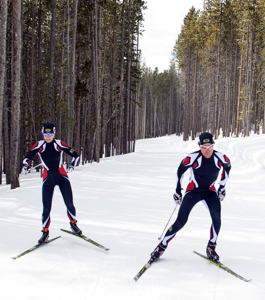 In this photo taken on Monday, Jan. 27, 2014, cross-country skiers Gary, right, and Angelica di Silvestri ski at the Yellowstone Club in Big Sky, Mont. The American-born man and his Italian-born wife will be representing the tiny Caribbean island nation of Dominica at the Winter Olympics in Sochi next month. The former finance professionals, granted Dominica citizenship for their philanthropic work on the island, are finishing their training in Montana while hastily arranging their own visas, travel logistics and footing the bill for the entire expedition. (AP Photo/Janie Osborne)
