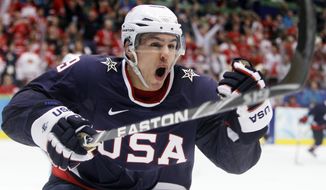 FILE - In this Feb. 28, 2010, file photo, USA&#39;s Zach Parise (9) celebrates after scoring a goal in the third period of the men&#39;s gold medal ice hockey game against Canada at the Vancouver 2010 Olympics in Vancouver, British Columbia. Parise, of the Minnesota Wild, will be the captain of the U.S. men&#39;s hockey team at the Sochi Olympics. (AP Photo/Gene J. Puskar, File)