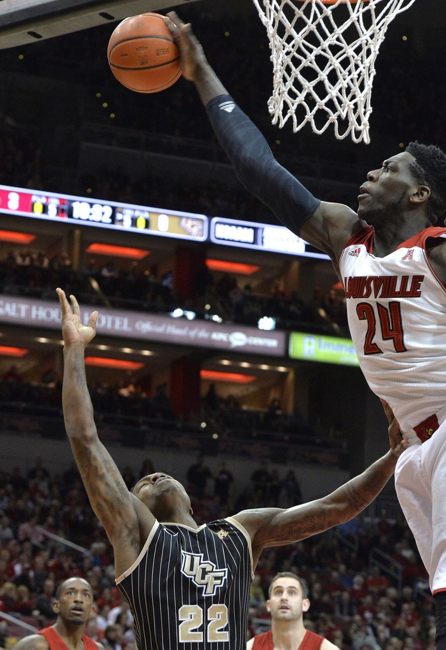 Louisville's Montrezl Harrell, right, blocks the shot of Central Florida's Brandon Goodwin during the first half of an NCAA college basketball game on Saturday, Feb. 1, 2014, in Louisville, Ky. (AP Photo/Timothy D. Easley)