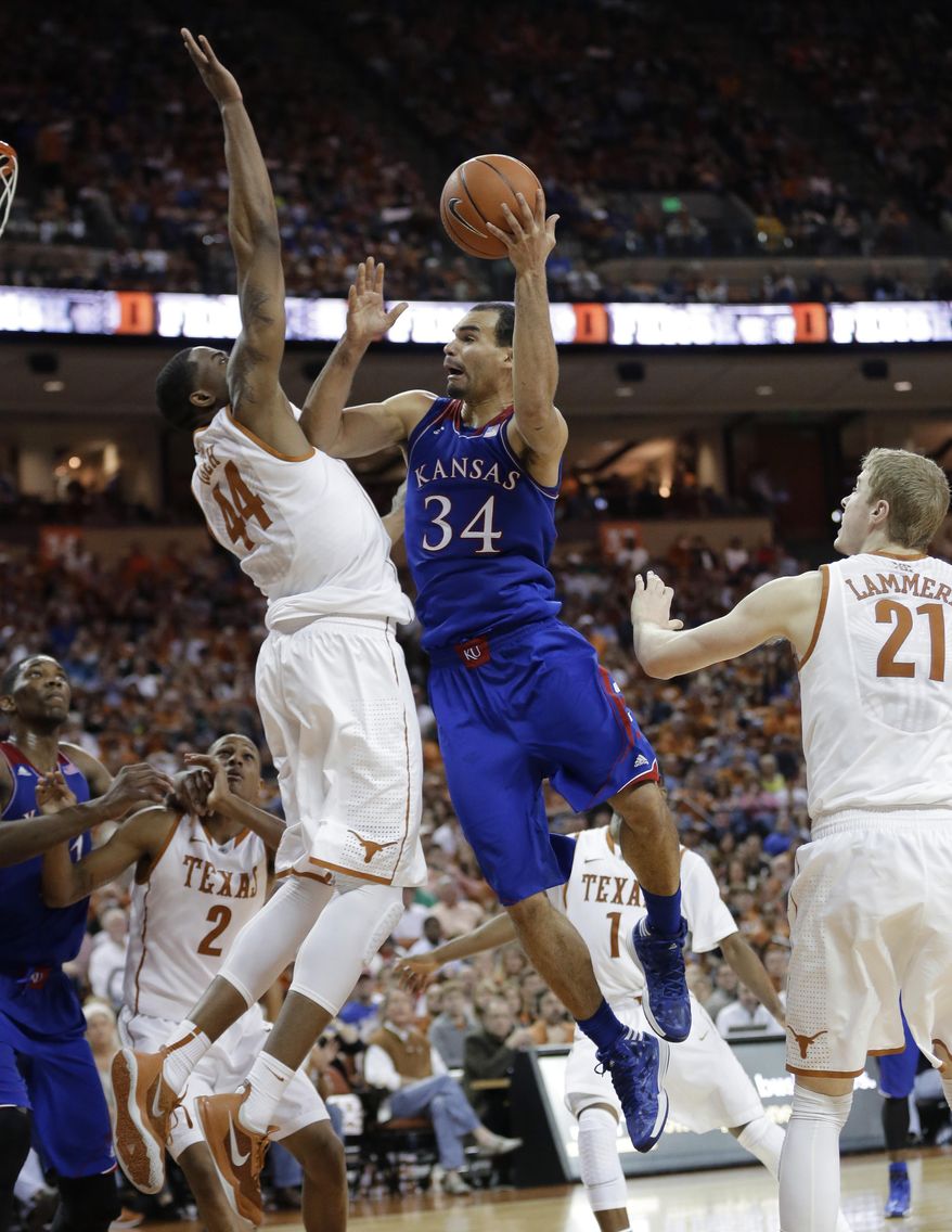 Kansas' Perry Ellis (34) shoots as Texas' Prince Ibeh (44) defends during the second half of an NCAA college basketball game, Saturday, Feb. 1, 2014, in Austin, Texas. Texas won 81-69. (AP Photo/Eric Gay)