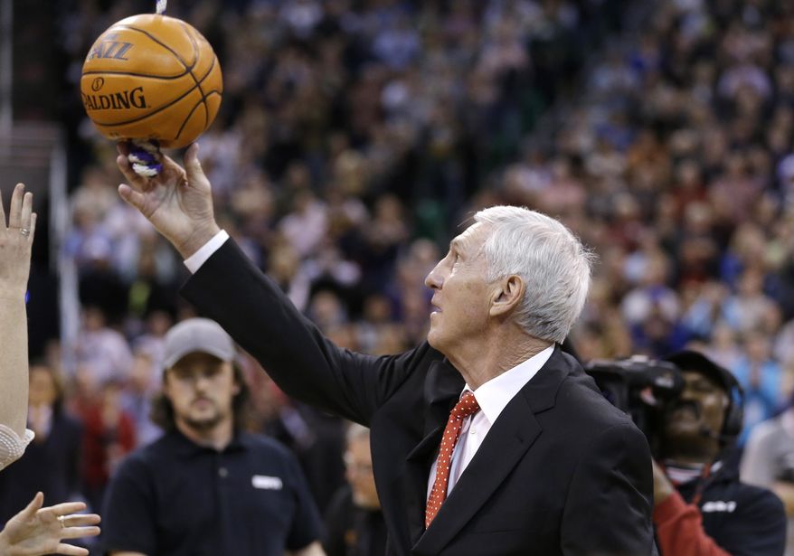 Former Jazz coach Jerry Sloan releases the ball after raising his banner during a banner ceremony honoring Jerry Sloan at the EnergySolutions Arena Friday, Jan. 31, 2014, in Salt Lake City. (AP Photo/Rick Bowmer)