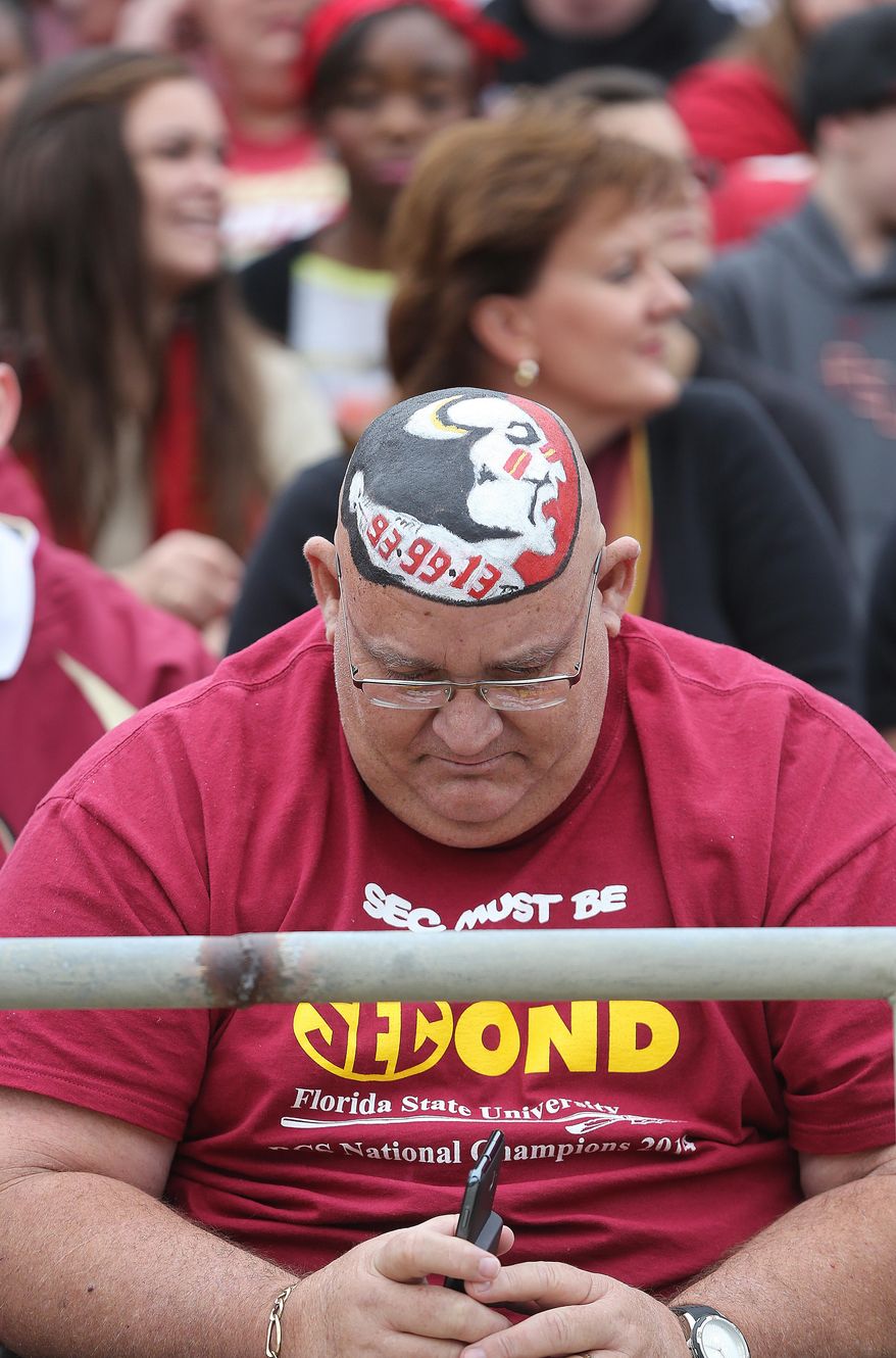 Florida State fan Bill Keen sports a Seminole logo during a celebration for the BCS-champion football team, Saturday, Feb. 1, 2014, in Tallahassee, Fla. (AP Photo/Tallahassee Democrat, Mike Ewen) NO SALES