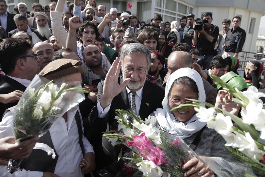 FILE - In this Sunday, Oct. 6, 2013 file photo, former Foreign Minister Zalmai Rassoul waves at his supporters after registering his candidacy in the 2014 presidential election in Kabul, Afghanistan. A former foreign minister, Rassoul has been national security adviser to the government and is seen as close to Karzai. He could end up being a consensus candidate among many political factions. A Pashtun like Karzai, he has a medical degree and is fluent in five languages, including French, English and Italian. (AP Photo/Rahmat Gul, File)