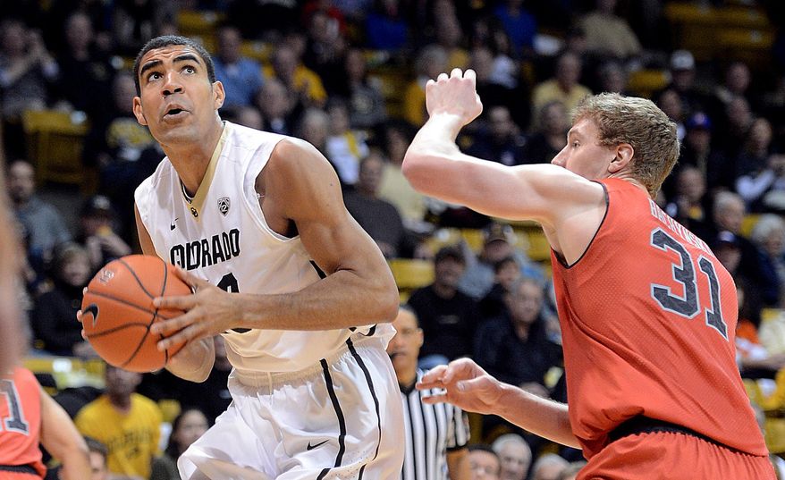 Colorado's Josh Scott, left, looks to shoot as Utah;s Dallin Bachynski defends during the first half of an NCAA college basketball game Saturday, Feb. 1, 2014, in Boulder, Colo. (AP Photo/The Daily Camera, Cliff Grassmick) NO SALES