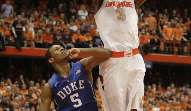 Syracuse’s Jerami Grant, right, jams the ball for two points against Duke’s Rodney Hood, left, in overtime of an NCAA college basketball game in Syracuse, N.Y., Saturday, Feb. 1, 2014. Syracuse won 91-89. (AP Photo/Nick Lisi)