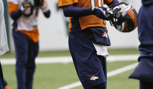 Denver Broncos quarterback Peyton Manning (18) puts his helmet on after stretching during practice Thursday, Jan. 30, 2014, in Florham Park, N.J. The Broncos are scheduled to play the Seattle Seahawks in the NFL Super Bowl XLVIII football game Sunday, Feb. 2, in East Rutherford, N.J. (AP Photo)