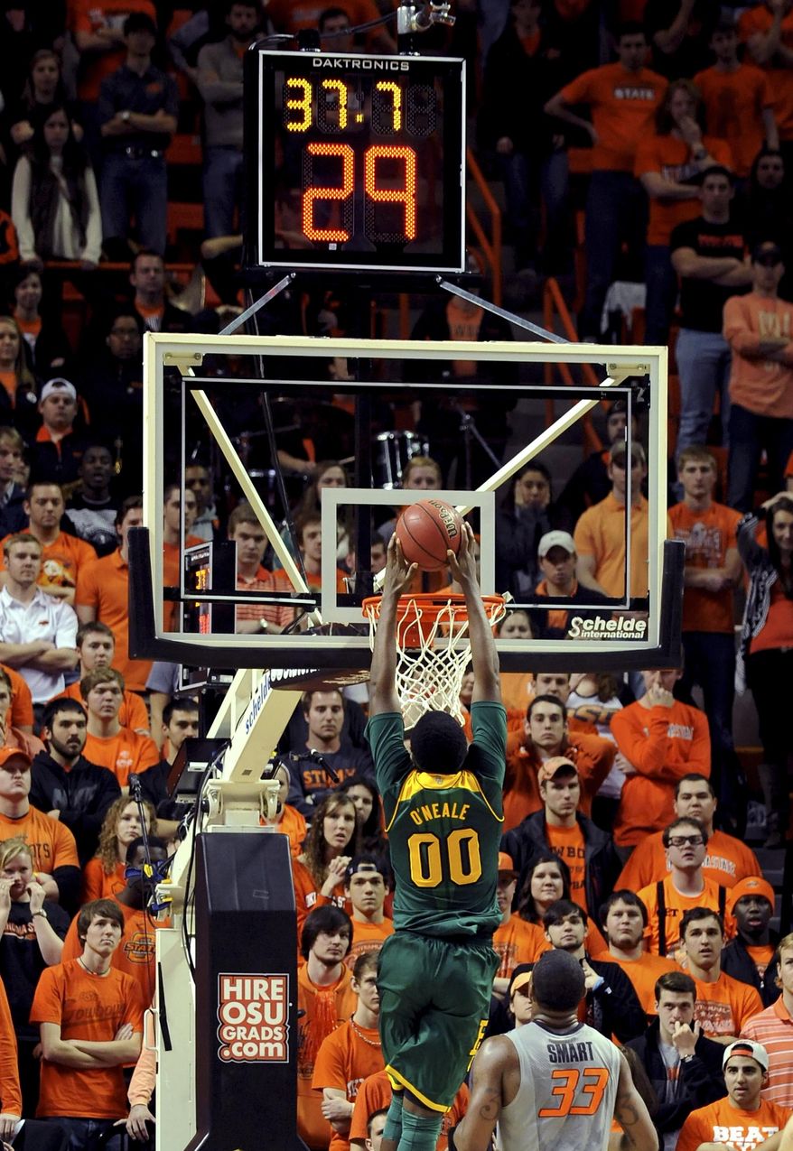 Oklahoma State fans watch as Baylor forward Royce O'Neal (00) dunks after getting past Oklahoma State's Marcus Smart (33) in the last minute of an NCAA college basketball game in Stillwater, Okla., Saturday, Feb. 1, 2014. O'Neal had 6 points in their 76-70 win over Oklahoma State. (AP Photo/Brody Schmidt)