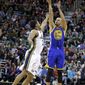Utah Jazz&#39;s Trey Burke, left, defends against Golden State Warriors&#39; Stephen Curry (30) as he shoots in the first quarter of an NBA basketball game Friday, Jan. 31, 2014, in Salt Lake City. (AP Photo/Rick Bowmer)
