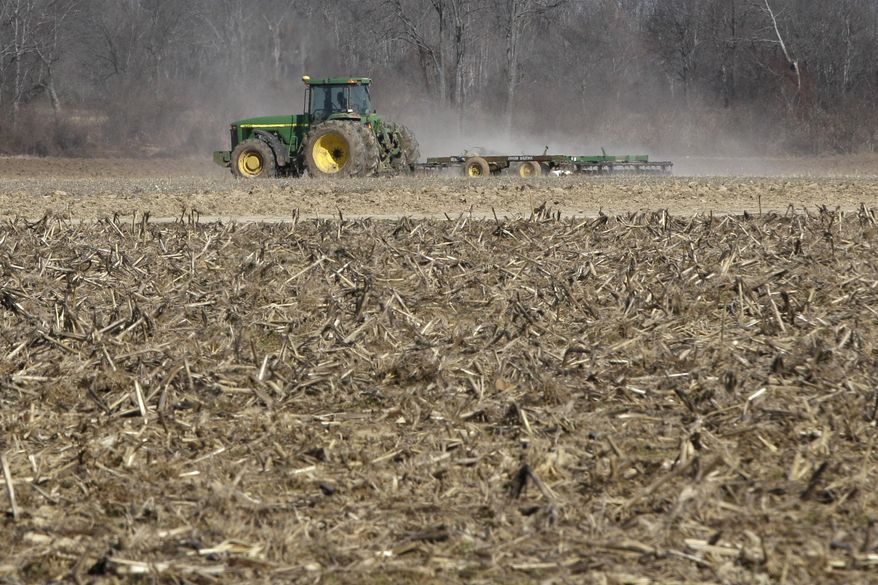 In this photo taken Thursday, Jan. 30, 2014, a farmer takes advantage of dry weather to till a field in preparation for spring planting near England, Ark. A new farm bill that could become law as soon as next week would require a choice between different subsidy approaches that require producers to suffer losses before they can get payouts. (AP Photo/Danny Johnston)
