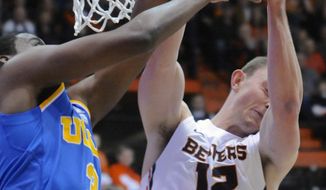 UCLA&#x27;s Jordan Adams (3) loses the ball to Oregon State&#x27;s Angus Brandt (12) during the first half of an NCAA college basketball game in Corvallis, Ore., Sunday, Feb. 2, 2014. (AP Photo/Greg Wahl-Stephens)
