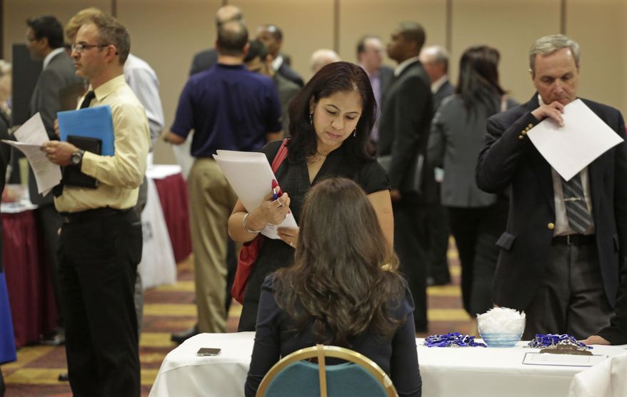 ADVANCE FOR USE MONDAY, FEB. 3, 2014, AND THEREAFTER - FILE - In this May 29, 2013 file photo, job seeker Anu Vatal of Chicago, speaks with Patrice Tosi of BluePay, seated, during a career fair in Rolling Meadows, Ill. Illinois Gov. Pat Quinn said in his State of the State address and recent interviews that Illinois economy is bouncing back strongly from recession. (AP Photo/M. Spencer Green, File)