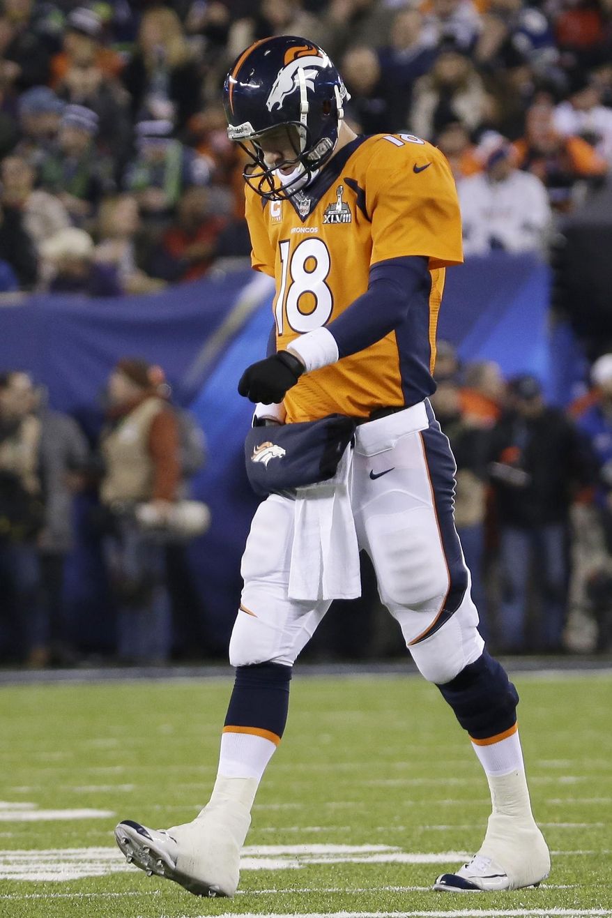 Denver Broncos' Peyton Manning walks off the field after throwing an interception against the Seattle Seahawks during the first half of the NFL Super Bowl XLVIII football game Sunday, Feb. 2, 2014, in East Rutherford, N.J. (AP Photo/Mark Humphrey)