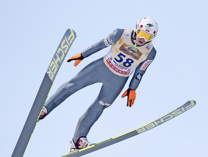 Winner Kamil Stoch of Poland soars through the air during the FIS World Cup ski jumping in Willingen, Germany, Sunday, Feb. 2, 2014. (AP Photo/Jens Meyer)