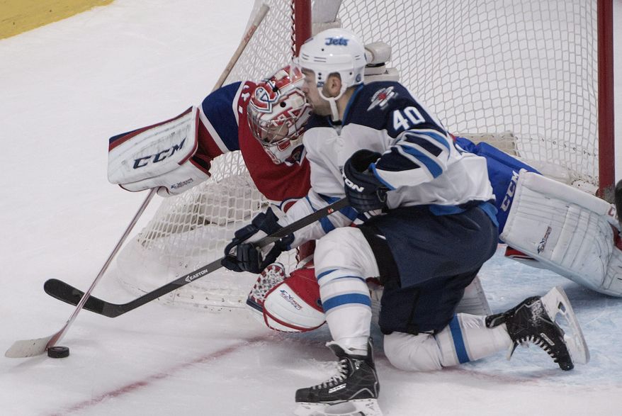Winnipeg Jets' Devin Setoguchi battles Montreal Canadiens goalie Carey Price for the puck during second period NHL action in Montreal, Sunday, Feb. 2, 2014. (AP Photo/The Canadian Press, Peter Mccabe)
